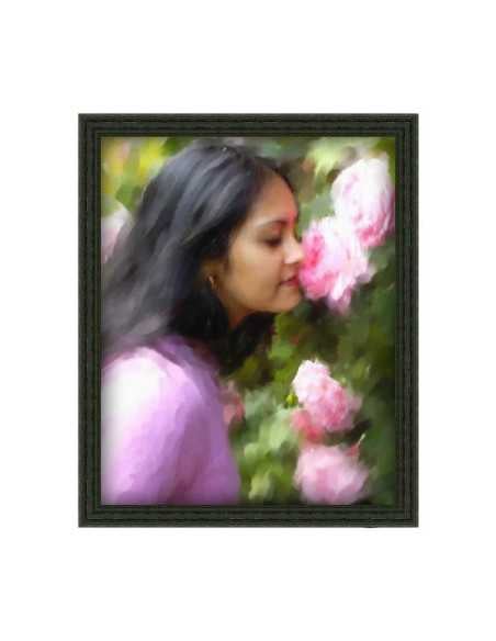 Painting in black frame of a lovely woman smelling roses, rendered by artist from a photo.